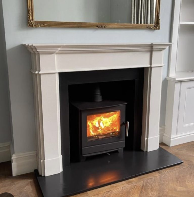 Scaffolding set up for chimney repair and maintenance on tiled roof of stone-built house by professional installers